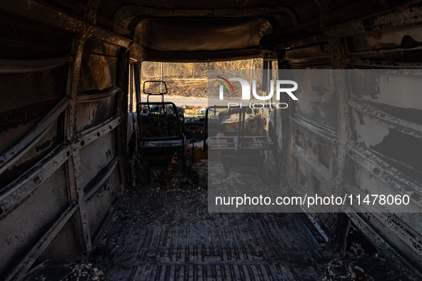 A destroyed car is sitting in a lumber warehouse in the Vrilissia area, due to the fire that broke out in Athens, Greece, on August 11, 2024...