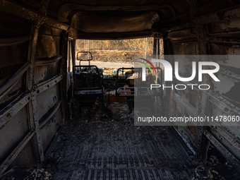 A destroyed car is sitting in a lumber warehouse in the Vrilissia area, due to the fire that broke out in Athens, Greece, on August 11, 2024...