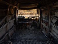 A destroyed car is sitting in a lumber warehouse in the Vrilissia area, due to the fire that broke out in Athens, Greece, on August 11, 2024...