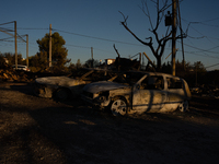 A destroyed car is sitting in a lumber warehouse in the Vrilissia area, due to the fire that broke out in Athens, Greece, on August 11, 2024...