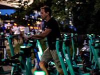 A man collects Bolt electric commercial scooter available for public commute in central Warsaw, the capital of Poland on August 14, 2024. (