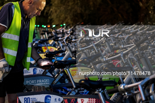 A man collects electric commercial bicycles available for public commute in central Warsaw, the capital of Poland on August 14, 2024. 