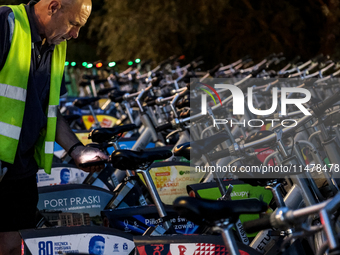 A man collects electric commercial bicycles available for public commute in central Warsaw, the capital of Poland on August 14, 2024. (