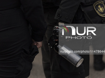 The Federal Police are holding pepper gas in their hand during a protest of Education Workers' Union in Buenos Aires, Argentina, on August 1...