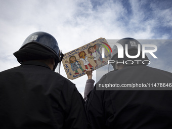 The teacher is showing a poster in defense of education to the Federal Police  during a protest of Education Workers' Union in Buenos Aires,...