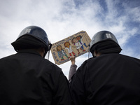 The teacher is showing a poster in defense of education to the Federal Police  during a protest of Education Workers' Union in Buenos Aires,...