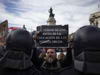 The teacher is showing a poster in defense of education to the Federal Police  during a protest of Education Workers' Union in Buenos Aires,...