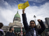 A teacher is holding a banner and asking the teachers union for a strike and fight plan  during a protest of Education Workers' Union in Bue...