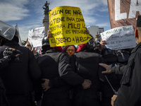 The teacher is showing a poster in defense of education to the Federal Police during a protest of Education Workers' Union in Buenos Aires,...