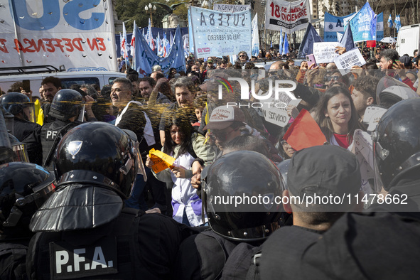 Federal Police are firing pepper spray at teachers who are demanding salary improvement during a protest of Education Workers' Union in Buen...