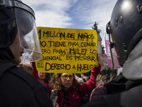 The teacher is showing a poster in defense of education to the Federal Police during a protest of Education Workers' Union in Buenos Aires,...