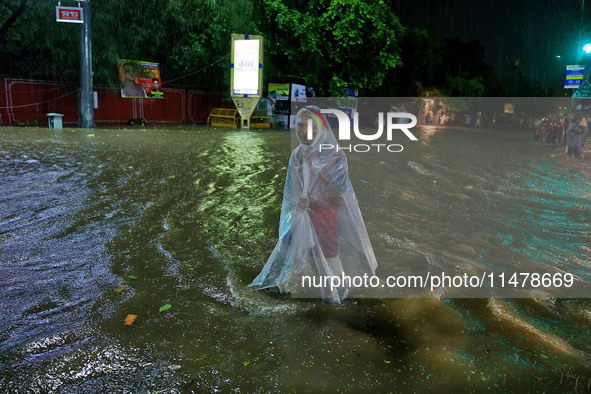 Locals are moving through the waterlogged road at Narayan Singh Circle following heavy monsoon rains, in Jaipur, Rajasthan, India, on August...