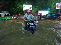 Vehicles are moving through the waterlogged road at Narayan Singh Circle following heavy monsoon rains in Jaipur, Rajasthan, India, on Wedne...