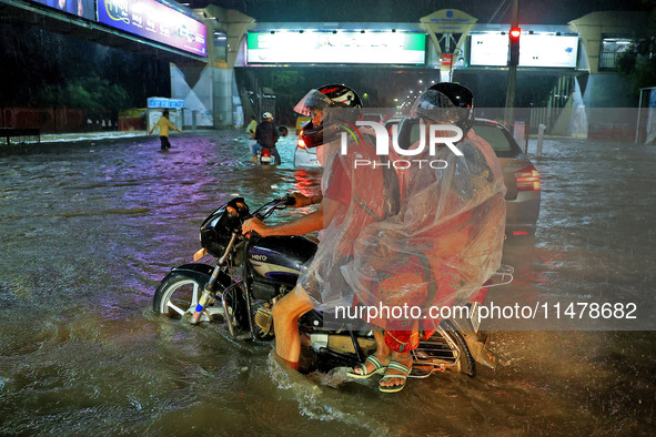 Vehicles are moving through the waterlogged road at Narayan Singh Circle following heavy monsoon rains in Jaipur, Rajasthan, India, on Wedne...