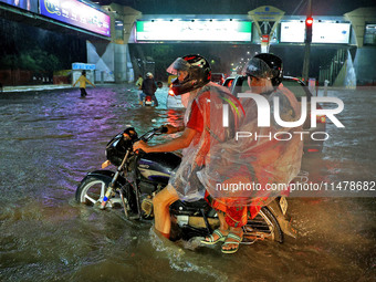 Vehicles are moving through the waterlogged road at Narayan Singh Circle following heavy monsoon rains in Jaipur, Rajasthan, India, on Wedne...