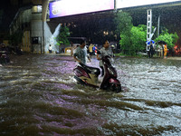 Vehicles are moving through the waterlogged road at Narayan Singh Circle following heavy monsoon rains in Jaipur, Rajasthan, India, on Wedne...