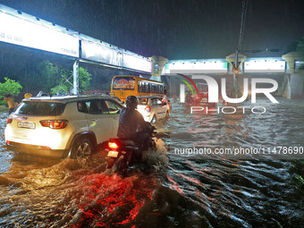 Vehicles are moving through the waterlogged road at Narayan Singh Circle following heavy monsoon rains in Jaipur, Rajasthan, India, on Wedne...