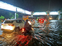 Vehicles are moving through the waterlogged road at Narayan Singh Circle following heavy monsoon rains in Jaipur, Rajasthan, India, on Wedne...