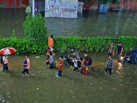 Vehicles and locals are moving through the waterlogged road at Narayan Singh Circle following heavy monsoon rains, in Jaipur, Rajasthan, Ind...