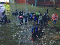 Vehicles and locals are moving through the waterlogged road at Narayan Singh Circle following heavy monsoon rains, in Jaipur, Rajasthan, Ind...