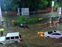 Vehicles and locals are moving through the waterlogged road at Narayan Singh Circle following heavy monsoon rains, in Jaipur, Rajasthan, Ind...