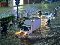 Vehicles are moving through the waterlogged road at Narayan Singh Circle following heavy monsoon rains in Jaipur, Rajasthan, India, on Wedne...