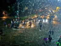 Vehicles and locals are moving through the waterlogged road at Narayan Singh Circle following heavy monsoon rains, in Jaipur, Rajasthan, Ind...