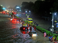 Vehicles and locals are moving through the waterlogged road at Narayan Singh Circle following heavy monsoon rains, in Jaipur, Rajasthan, Ind...