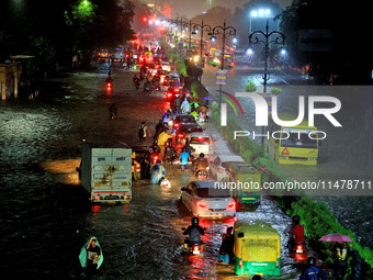 Vehicles are moving through the waterlogged road at Narayan Singh Circle following heavy monsoon rains in Jaipur, Rajasthan, India, on Wedne...