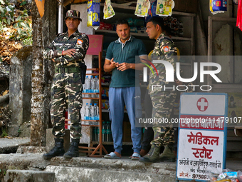 Soldiers from the Indian army are speaking with locals while on patrol in Kathgodam, Uttarakhand, India, on April 21, 2024. (