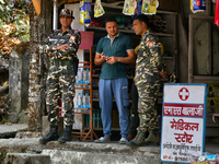 Soldiers from the Indian army are speaking with locals while on patrol in Kathgodam, Uttarakhand, India, on April 21, 2024. (