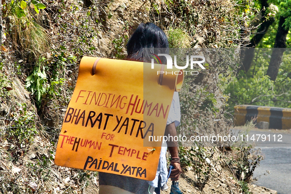 A man is walking as he takes part in the Paidal Yatra for the Human Temple in Kathgodam, Uttarakhand, India, on April 21, 2024. 