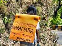 A man is walking as he takes part in the Paidal Yatra for the Human Temple in Kathgodam, Uttarakhand, India, on April 21, 2024. (