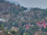 Hindu temples and other buildings are lining the mountainside in Kathgodam, Uttarakhand, India, on April 21, 2024. Kathgodam is a suburb of...