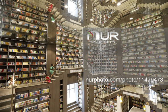 A child is reading at Boya Bookstore in Zixing, China, on August 12, 2024. 