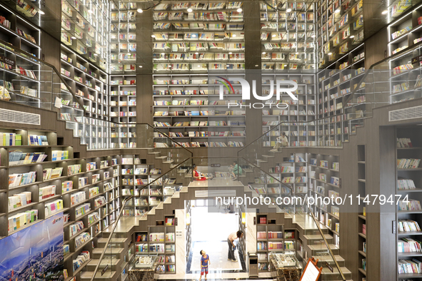 A child is reading at Boya Bookstore in Zixing, China, on August 12, 2024. 