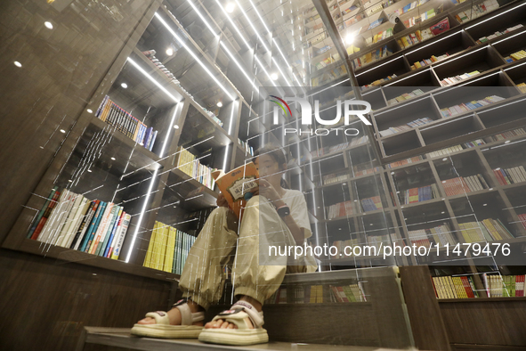 A child is reading at Boya Bookstore in Zixing, China, on August 12, 2024. 