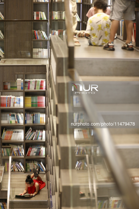 A child is reading at Boya Bookstore in Zixing, China, on August 12, 2024. 