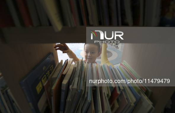 A child is reading at Boya Bookstore in Zixing, China, on August 12, 2024. 