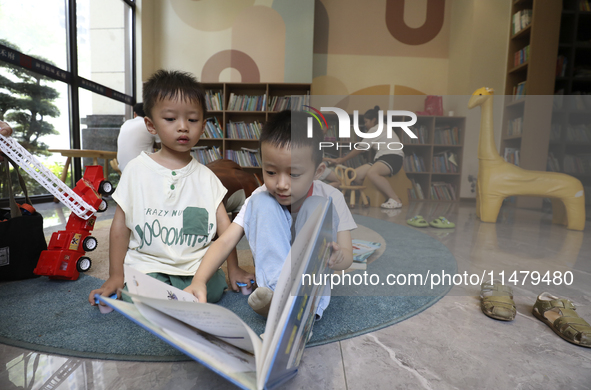 A child is reading at Boya Bookstore in Zixing, China, on August 12, 2024. 