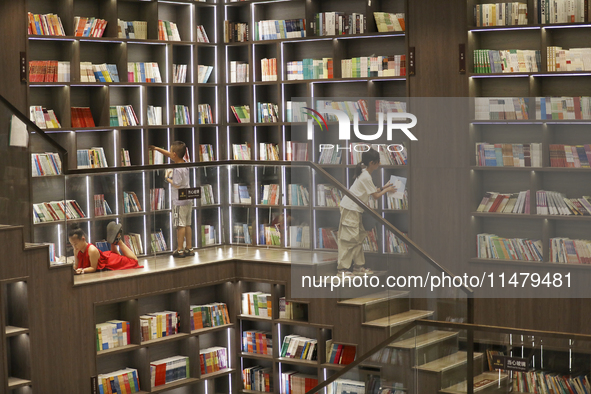 A child is reading at Boya Bookstore in Zixing, China, on August 12, 2024. 