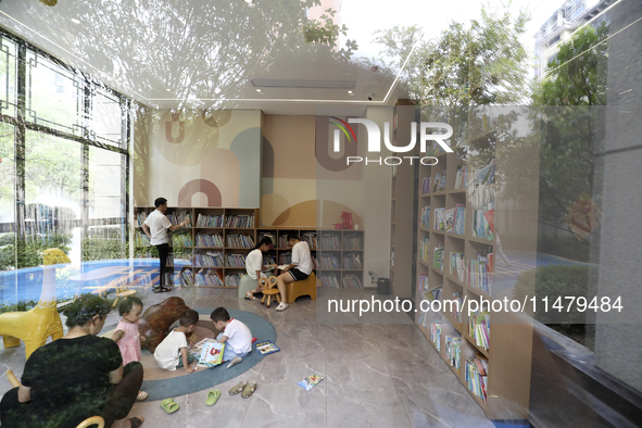 A child is reading at Boya Bookstore in Zixing, China, on August 12, 2024. 