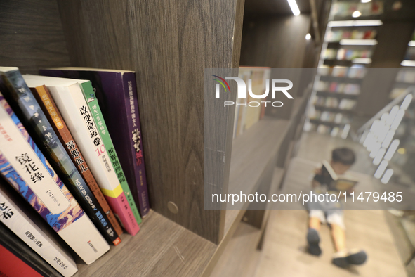 A child is reading at Boya Bookstore in Zixing, China, on August 12, 2024. 