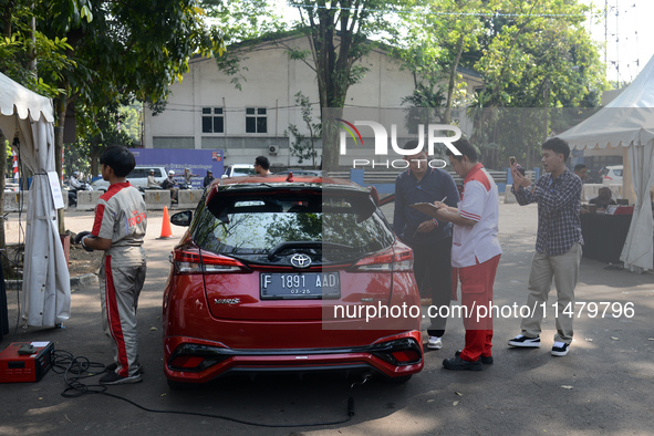 A car is being seen at one of the emission test locations during an exhaust emissions test (AU) in Bogor, West Java, Indonesia, on August 15...