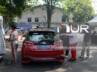 A car is being seen at one of the emission test locations during an exhaust emissions test (AU) in Bogor, West Java, Indonesia, on August 15...