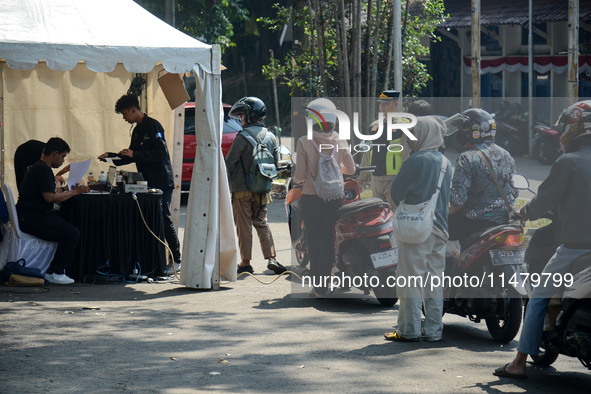 Queues of motorcycles are being seen at one of the emission test locations in Bogor, West Java, Indonesia, on August 15, 2024. This policy i...