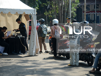 Queues of motorcycles are being seen at one of the emission test locations in Bogor, West Java, Indonesia, on August 15, 2024. This policy i...