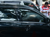 An officer is writing down notes during emission testing at one of the emission test locations in Bogor, West Java, Indonesia, on August 15,...