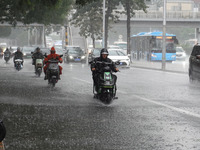 Vehicles and pedestrians are making their way through the rain on the East Third Ring Road in Beijing, China, on August 15, 2024. (