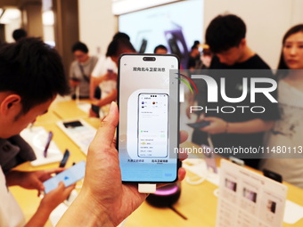 Visitors are shopping for a Huawei Mate60 mobile phone that supports Beidou satellite calls at the Huawei flagship store in Shanghai, China,...